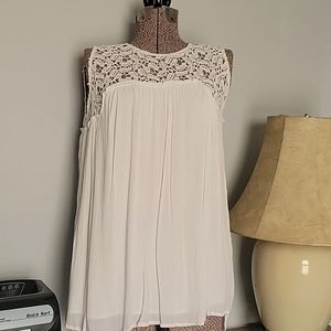 Sleeveless free flowing top with lace.  Lightweight fabric with layers under